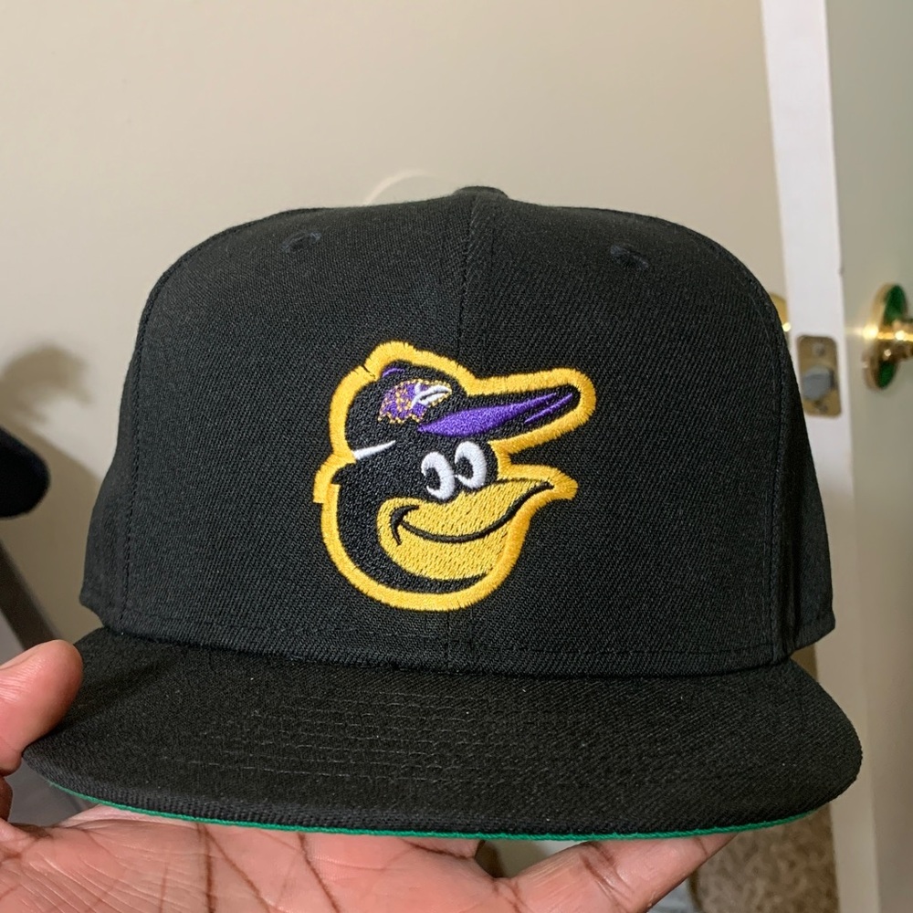 Baltimore Orioles wearing a Ravens hat